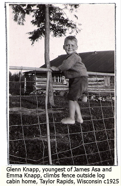 Glenn Knapp climbing fence outside of Knapp log cabin, Taylor Rapids, Wisconsin, c1925.