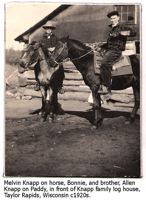 Melvin and Allen Knapp ride their horses in front of the Knapp family log cabin c1920s
