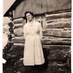 Nora Knapp in front of log cabin home in Taylor Rapids, Wisconsin, 1923