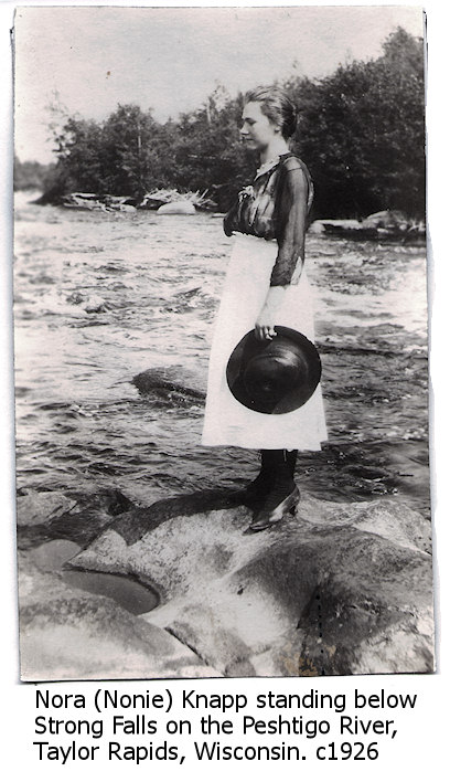Nora Knapp standing below Strong Falls on the Peshtigo River, Taylor Rapids, Wisconsin circa 1926