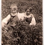 Robert and Wayne Knapp circa 1920s, outside log cabin in garden, Taylor Rapids, Wisconsin