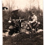 Robert Knapp with trout catch and Wayne Knapp plays with frog along Peshtigo River, Taylor Rapids, Wisconsin circa 1924