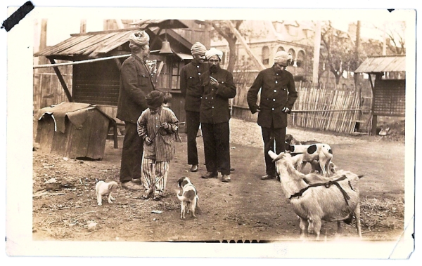Men in turbans in unknown location - with boy and goats - from the scrapbook of Howard W. West Sr. circa 1925.